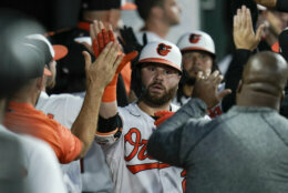 Baltimore Orioles' DJ Stewart, center, is greeted in the dugout after hitting a two-run home run off Minnesota Twins starting pitcher Randy Dobnak during the fifth inning of a baseball game, Wednesday, June 2, 2021, in Baltimore. Orioles' Freddy Galvis scored on the home run. (AP Photo/Julio Cortez)