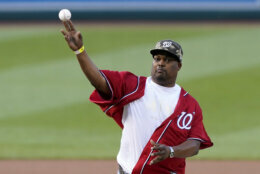 U.S. Capitol Police officer Eugene Goodman throws out the first pitch before the Washington Nationals baseball game against the New York Mets, Friday, June 18, 2021, in Washington. (AP Photo/Carolyn Kaster)
