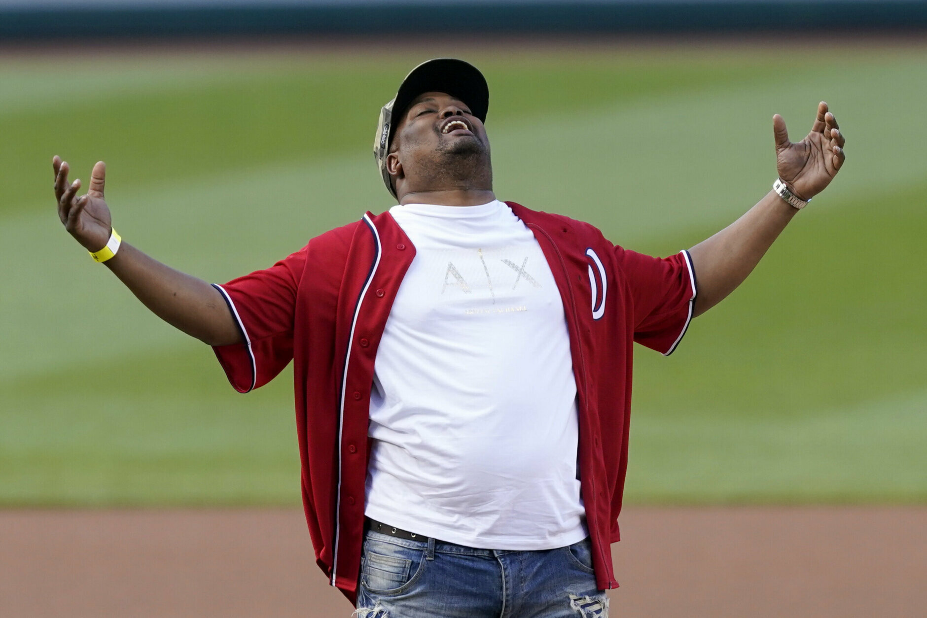 U.S. Capitol Police officer Eugene Goodman reacts after throwing out the first pitch before the Washington Nationals baseball game against the New York Mets, Friday, June 18, 2021, in Washington. (AP Photo/Carolyn Kaster)