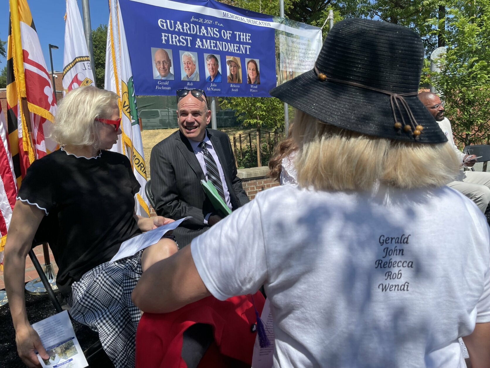 Survivors and family members of victims of the five people who died in a mass shooting at the Capital Gazette newspaper dedicated a memorial to them and the First Amendment on Monday on the third anniversary of the attack (WTOP/Meghan Cloherty).