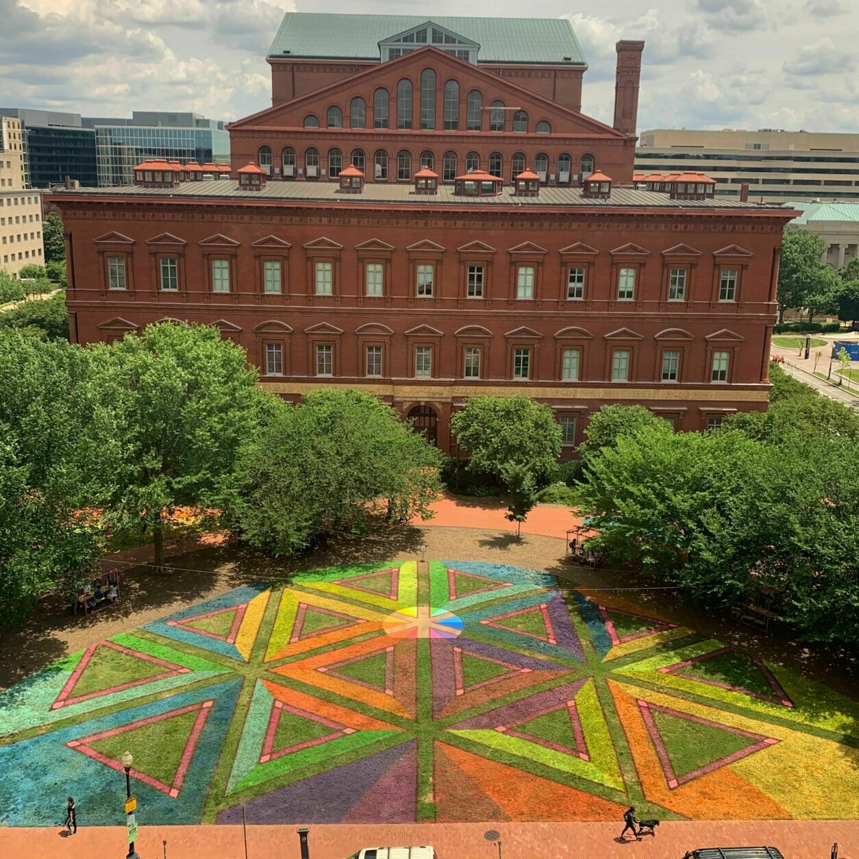 Artist Lisa Marie Thalhammer  of DC was commissioned by the Downtown DC Business Improvement District earlier this year, to use her artistic talents to create a design using lawn paint that promotes social distancing for the organization’s DowntownDC Summer Flicks series. It's called "Equilateral Network."