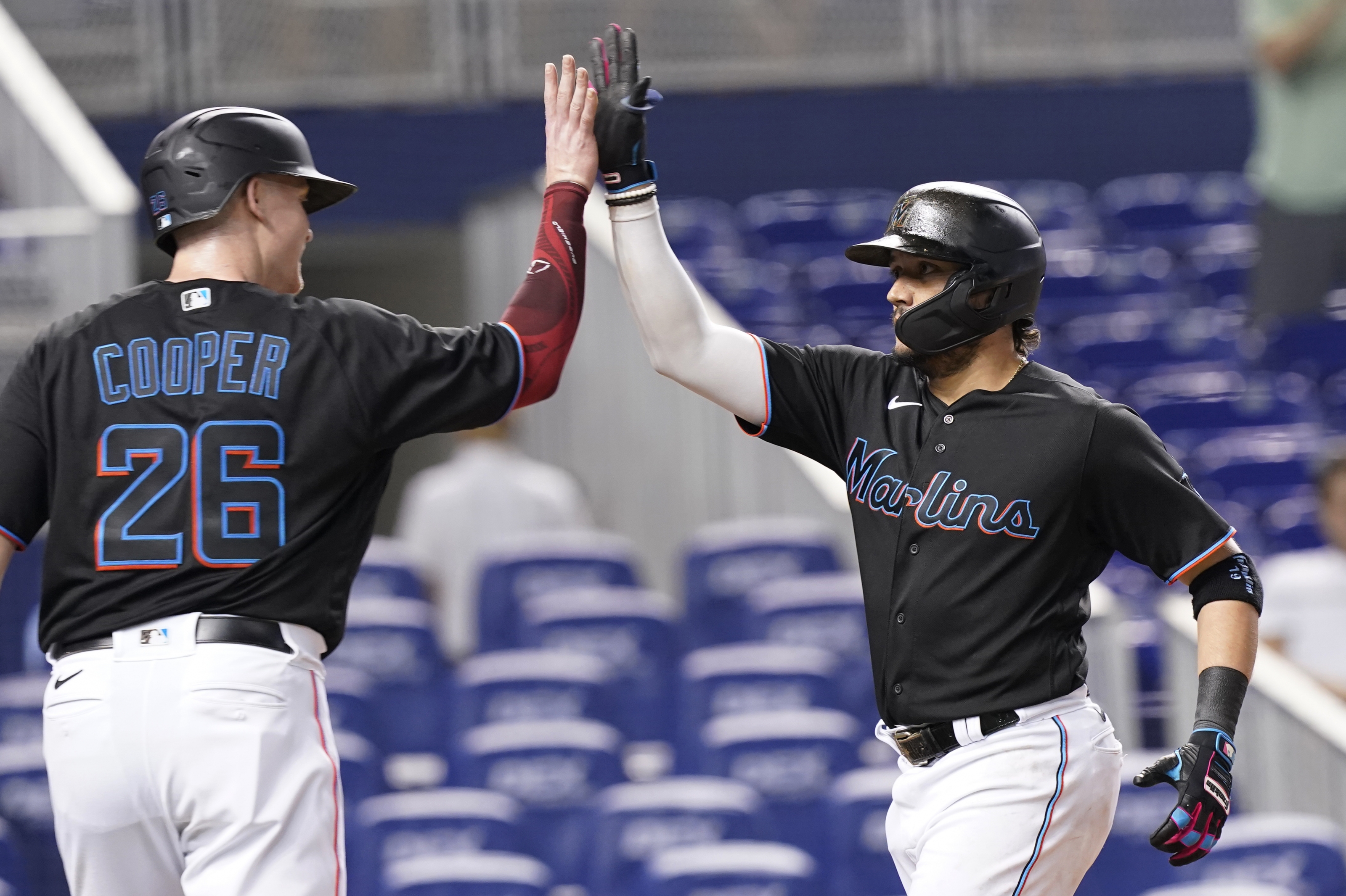 Miami Marlins first baseman Garrett Cooper (26) throws from the