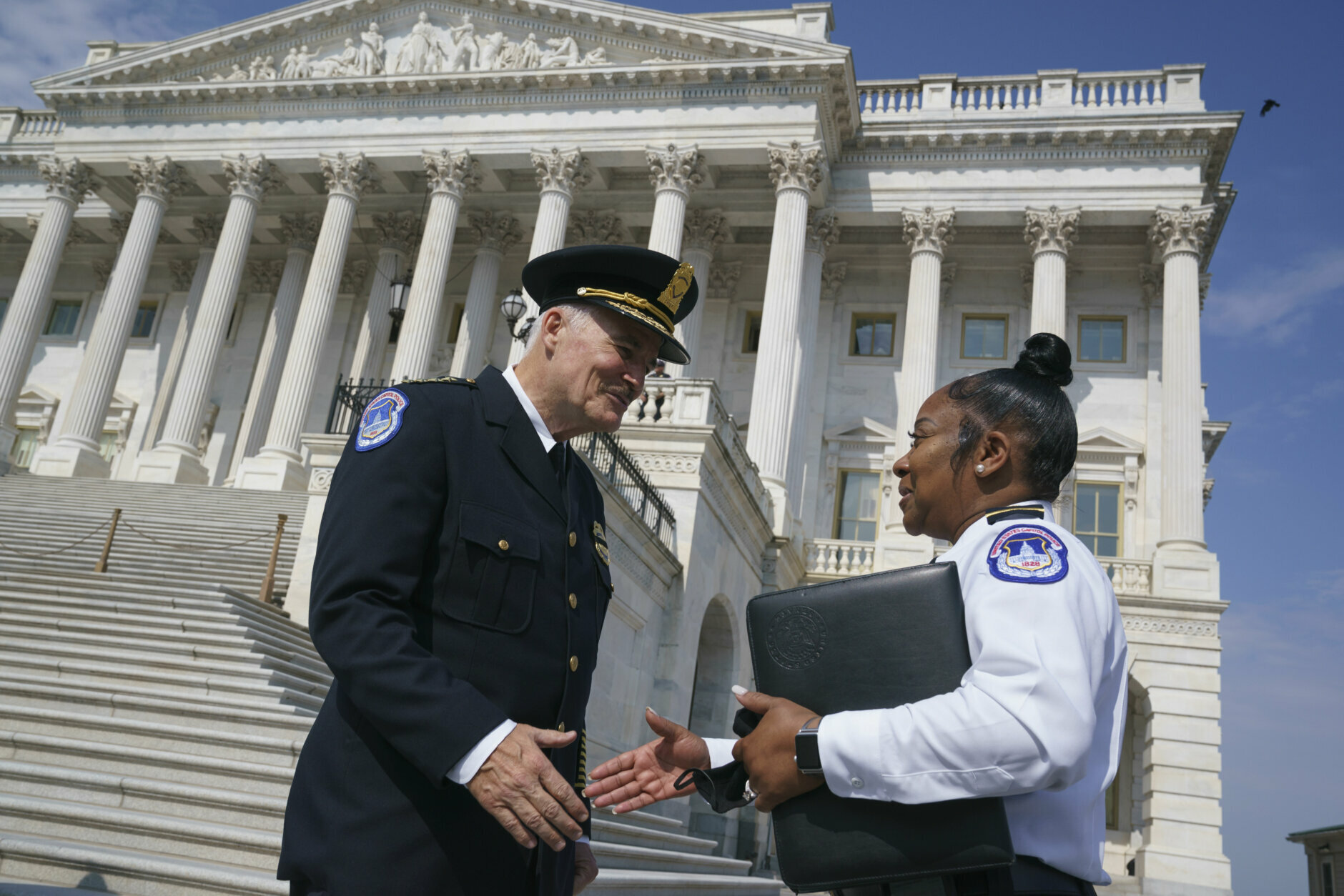 J. Thomas Manger, left, a veteran police chief of departments in the Washington, D.C., region, is welcomed by interim acting Capitol Police chief Yogananda Pittman, to the Capitol in Washington, Friday, July 23, 2021, as he takes over the United States Capitol Police following the resignations of the previous leadership after the Jan. 6 insurrection. (AP Photo/J. Scott Applewhite)