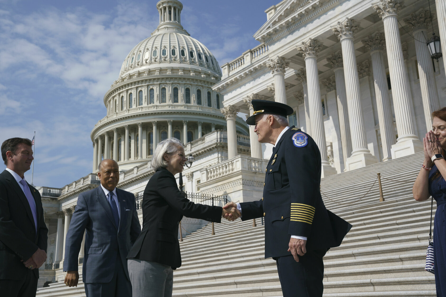 J. Thomas Manger, right, a veteran police chief of departments in the Washington, D.C., region, is welcomed by Senate Sergeant at Arms Karen Gibson to the Capitol in Washington, Friday, July 23, 2021. Manger takes over the United States Capitol Police following the resignations of the previous leadership after the Jan. 6 insurrection. (AP Photo/J. Scott Applewhite)