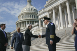 J. Thomas Manger, right, a veteran police chief of departments in the Washington, D.C., region, is welcomed by Senate Sergeant at Arms Karen Gibson to the Capitol in Washington, Friday, July 23, 2021. Manger takes over the United States Capitol Police following the resignations of the previous leadership after the Jan. 6 insurrection. (AP Photo/J. Scott Applewhite)