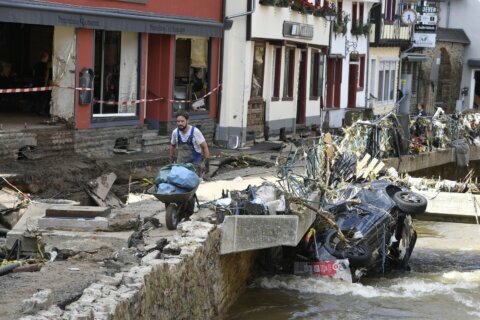 Merkel tours ‘surreal’ flood scene, vows aid, climate action