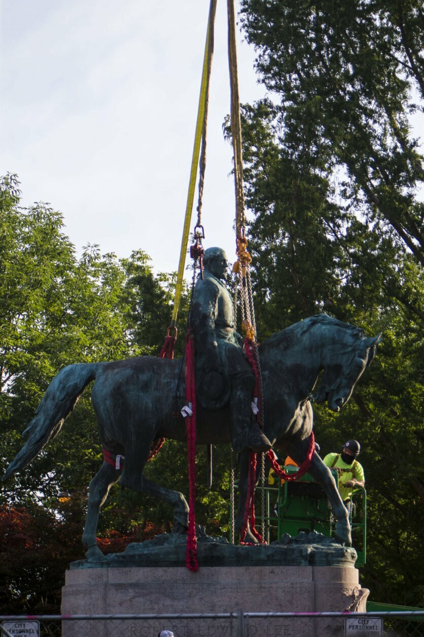 Workers prepare to remove the monument of Confederate General Robert E. Lee on Saturday, July 10, 2021 in Charlottesville, Va.   The removal of the Lee statue follows years of contention, community anguish and legal fights. (AP Photo/John C. Clark)