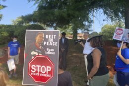 Activists gather for a vigil on Tuesday, July 27, 2021 near the McDonald’s restaurant in Gaithersburg, Md. where Ryan LeRoux, a 21-year-old Black man, was shot and killed by police on July 16. (AP Photo/Michael Kunzelman)