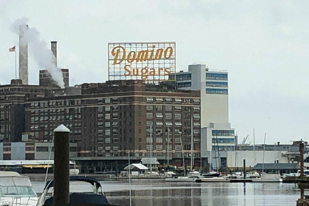 The Domino Sugars sign as seen from the harbor in Baltimore, Maryland in the spring of 2021.