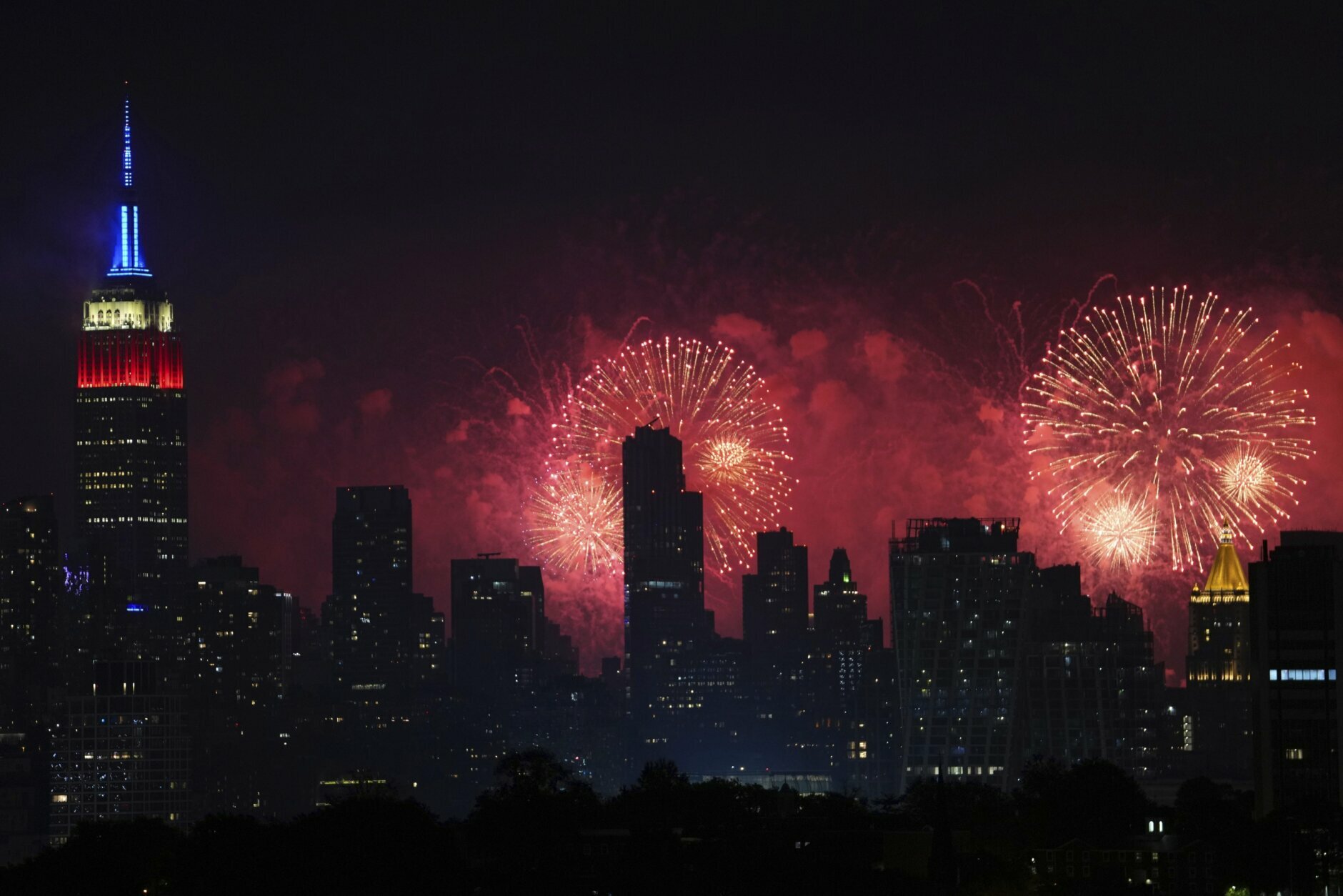 Fireworks explode over the New York City skyline during Macy's 4th of July fireworks display, late Sunday, July 4, 2021, as seen from Jersey City, N.J. (AP Photo/Charles Sykes)