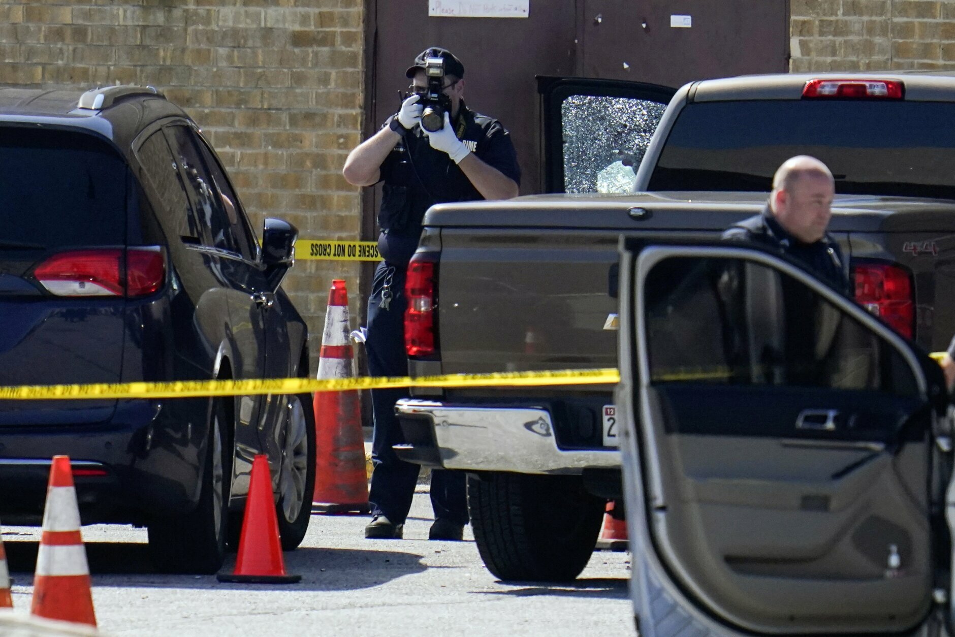 <p>Shattered glass is seen on a pickup&#8217;s driver side door as investigators document the scene in a mall parking area where two Baltimore city police officers were shot and a suspect was killed as a U.S. Marshals’ task force served a warrant, Tuesday, July 13, 2021, in Baltimore, Md. The police officers were taken to the University of Maryland Medical Center with injuries that aren’t thought to be life-threatening, county police spokeswoman Joy Stewart said.(AP Photo/Julio Cortez)</p>
