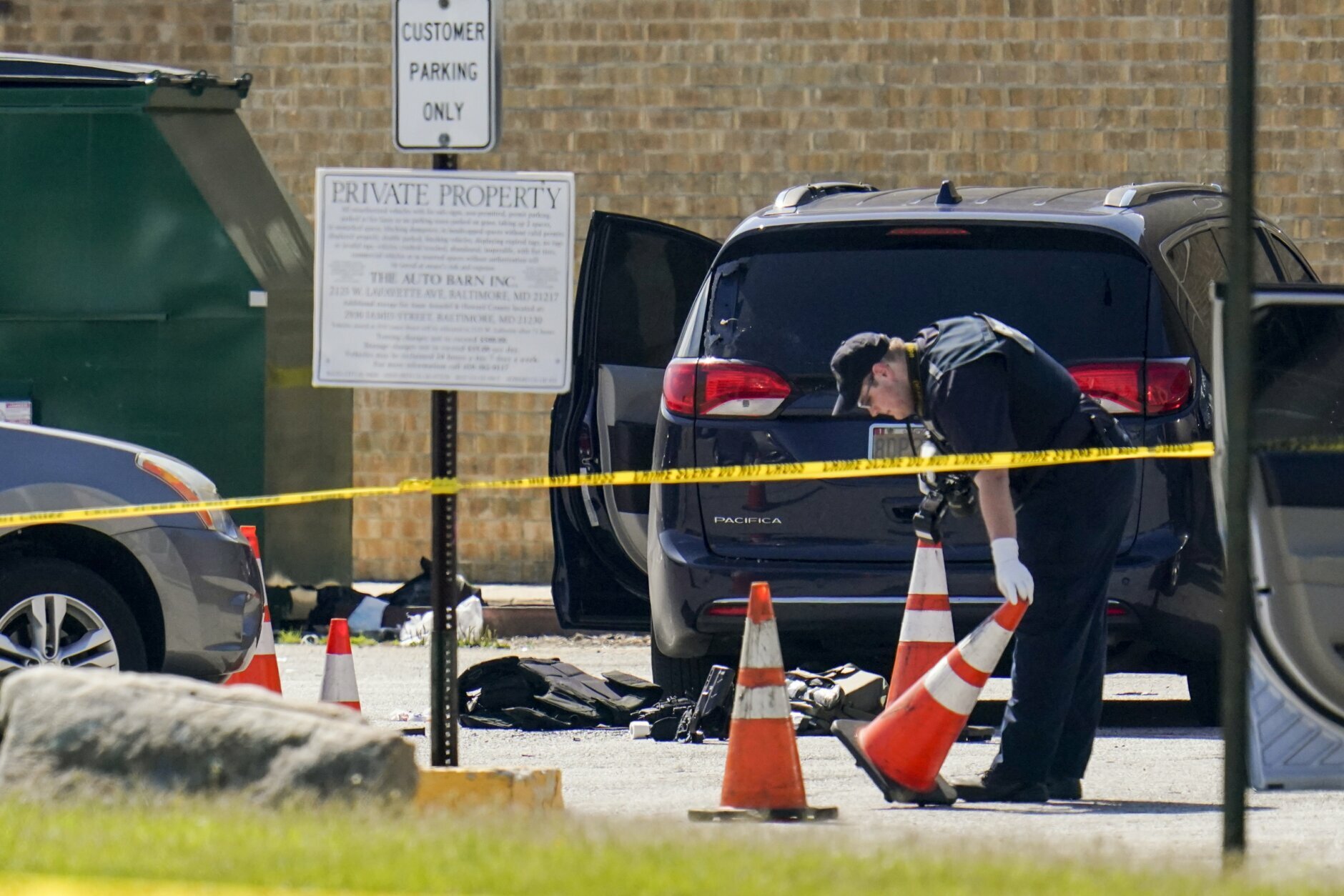 <p>Body armor is seen near a minivan as a forensics worker inspects an area where two officers on the U.S. Marshals&#8217; task force were allegedly shot in Baltimore, according to officials, Tuesday, July 13, 2021. The Marshal&#8217;s wounds aren&#8217;t thought to be life-threatening. (AP Photo/Julio Cortez)</p>

