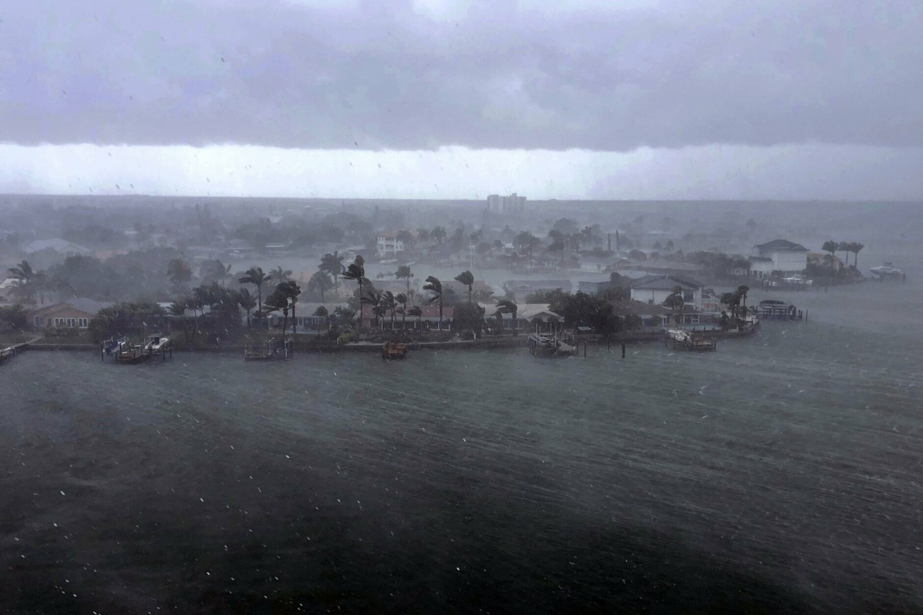 Looking north at the neighborhood of Paradise Island on Treasure Island, Fla., outer bands of Tropical Storm Elsa brings a downpour of rain over the area on Tuesday afternoon, July 6, 2021. Elsa is expected to impact the Tampa Bay area the heaviest during the predawn hours of Wednesday morning. (Marc Topkin/Tampa Bay Times via AP)