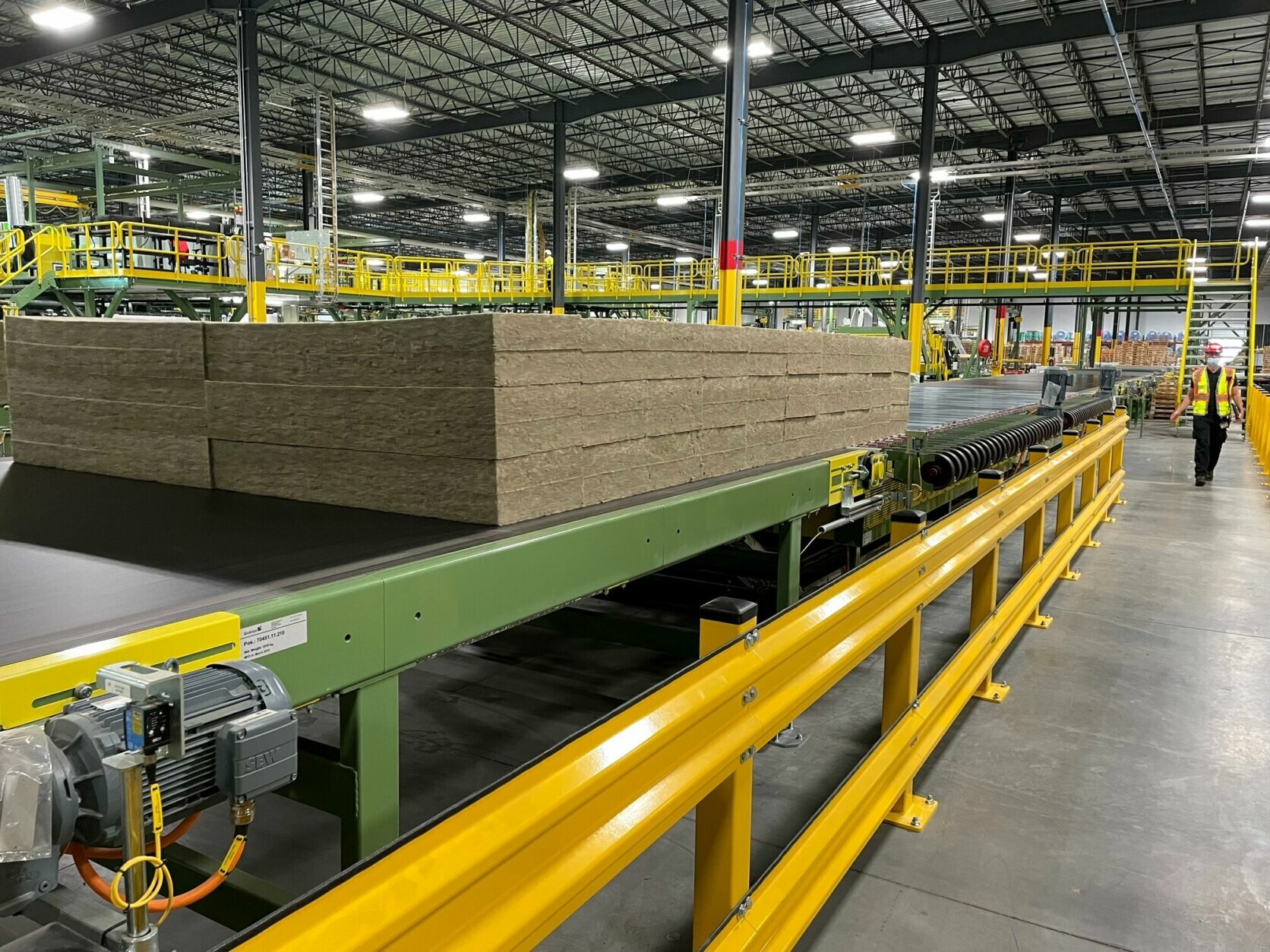 <p>Large conveyor belts transport the stone wool through the factory, where machines cut them into specific sizes and products.</p>
<p>The Ranson facility is Rockwool&#8217;s second U.S. factory; the other is in Byhalia, Mississippi.</p>
<p>&nbsp;</p>
