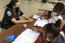DC officer Crystal Ruiz is a 14 year veteran of the department. She chats with two participants in the "Think Like a Queen" event. (WTOP/Kristi King)