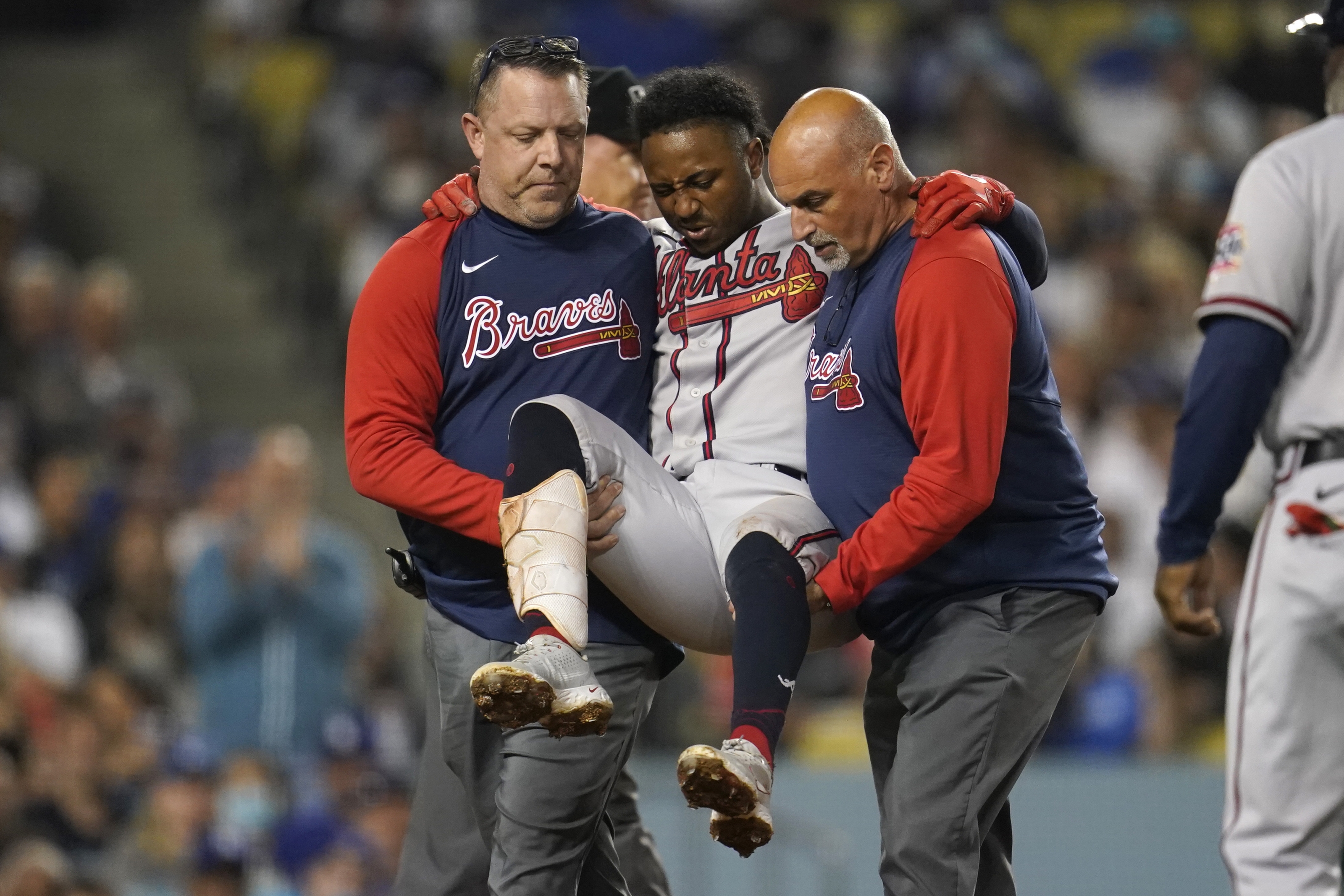 Braves star Albies carried away after fouling ball off knee - WTOP
