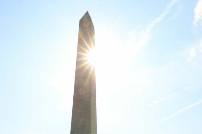 WASHINGTON, DC - AUGUST 12: People walk toward the Washington Monument on the National Mall where temperatures neared 100-degrees across the region for a second day in a row on August 12, 2021 in Washington, DC. Heat domes in Pacific Northwest and the East are generating a wide expanse of abnormally high temperatures have put 150 million Americans under alert. (Photo by Chip Somodevilla/Getty Images)