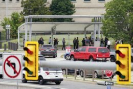 Police vehicles are seen outside the Pentagon Metro area Tuesday, Aug. 3, 2021, at the Pentagon in Washington. The Pentagon is on lockdown after multiple gunshots were fired near a platform by the facility's Metro station. (AP Photo/Andrew Harnik)