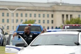 A Pentagon Police officer is seen outside the Pentagon, Tuesday, August 3, 2021 at the Pentagon in Washington. The Pentagon is on lockdown after multiple gunshots were fired near a platform by the facility's Metro station. Two people familiar with the shooting, which occurred on a Metro bus platform at the Pentagon, said at least one person was down. They spoke on condition of anonymity because they were not authorized to release information publicly. (AP Photo/Andrew Harnik)
