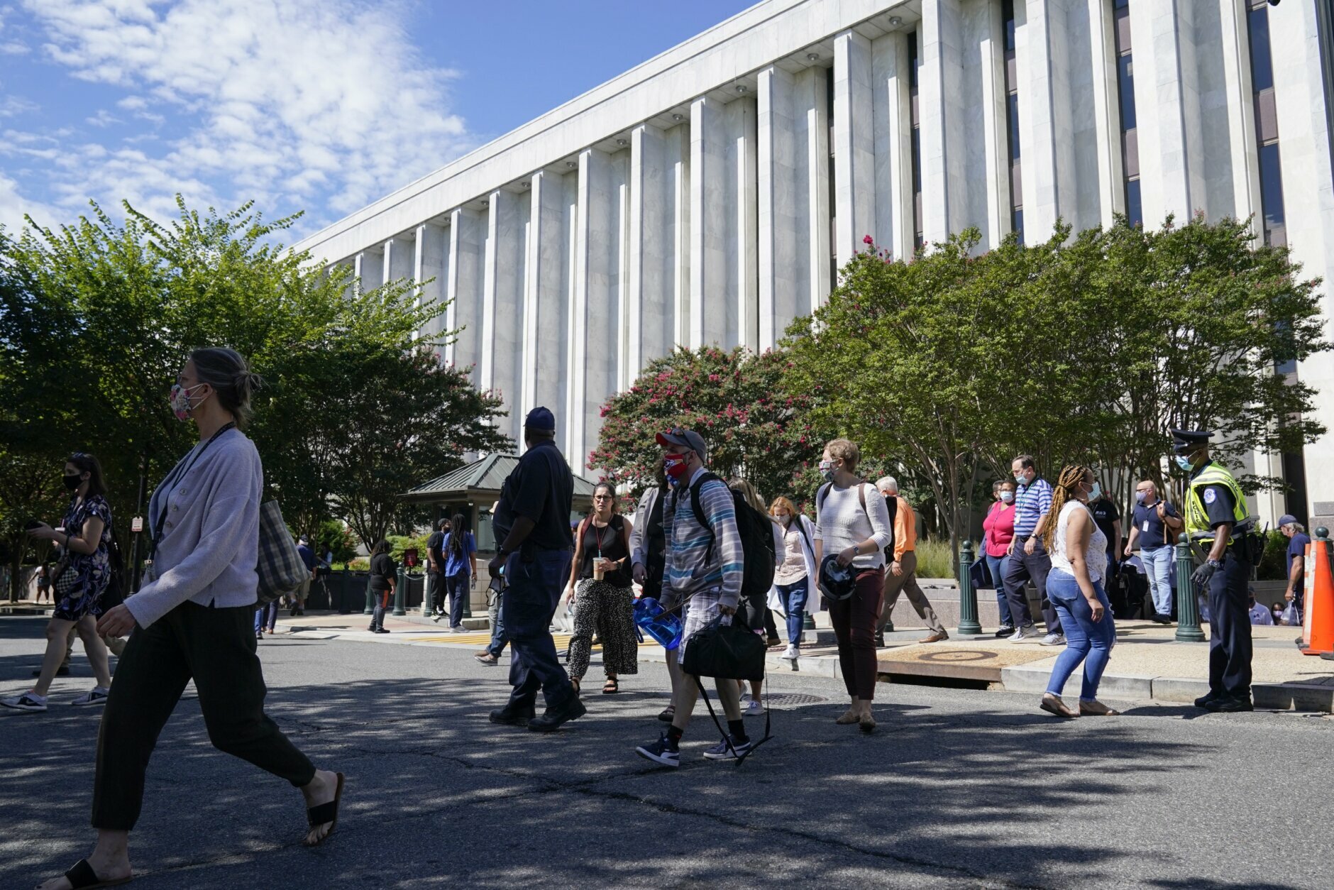 People are evacuated from the James Madison Memorial Building, a Library of Congress building, in Washington on Thursday, Aug. 19, 2021, as law enforcement investigate a report of a pickup truck containing an explosive device near the U.S. Capitol. (AP Photo/Alex Brandon)