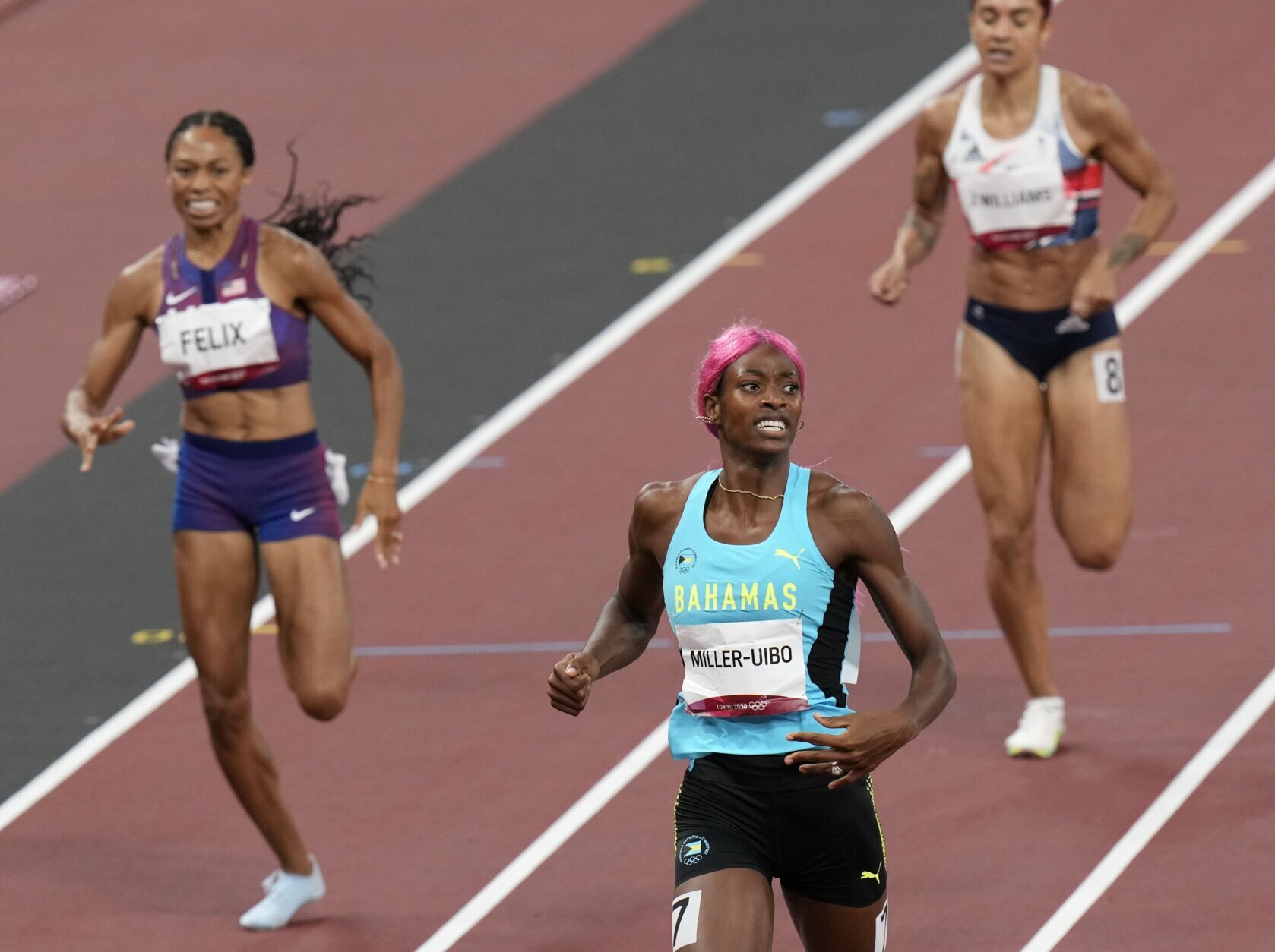 Shaunae Miller-Uibo, of Bahamas crosses the line to win the gold medal ahead of Allyson Felix, of United States, bronze, in the final of women's 400-meters at the 2020 Summer Olympics, Friday, Aug. 6, 2021, in Tokyo, Japan. (AP Photo/Francisco Seco)