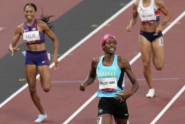 Shaunae Miller-Uibo, of Bahamas crosses the line to win the gold medal ahead of Allyson Felix, of United States, bronze, in the final of women's 400-meters at the 2020 Summer Olympics, Friday, Aug. 6, 2021, in Tokyo, Japan. (AP Photo/Francisco Seco)
