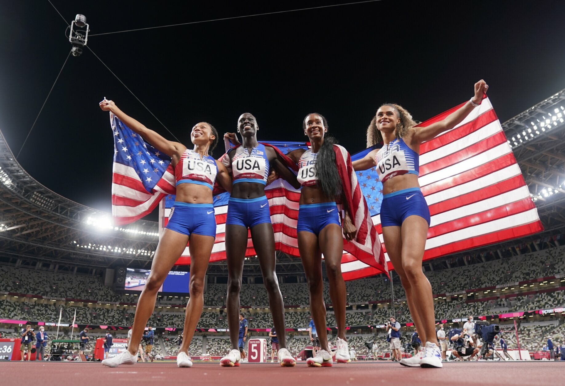 The United States team of Allyson Felix, Athing Mu, Dalilah Muhammad and Sydney Mclaughlin, from left, celebrate winning the gold medal in the final of the women's 4 x 400-meter relay at the 2020 Summer Olympics, Saturday, Aug. 7, 2021, in Tokyo, Japan. (AP Photo/Charlie Riedel)