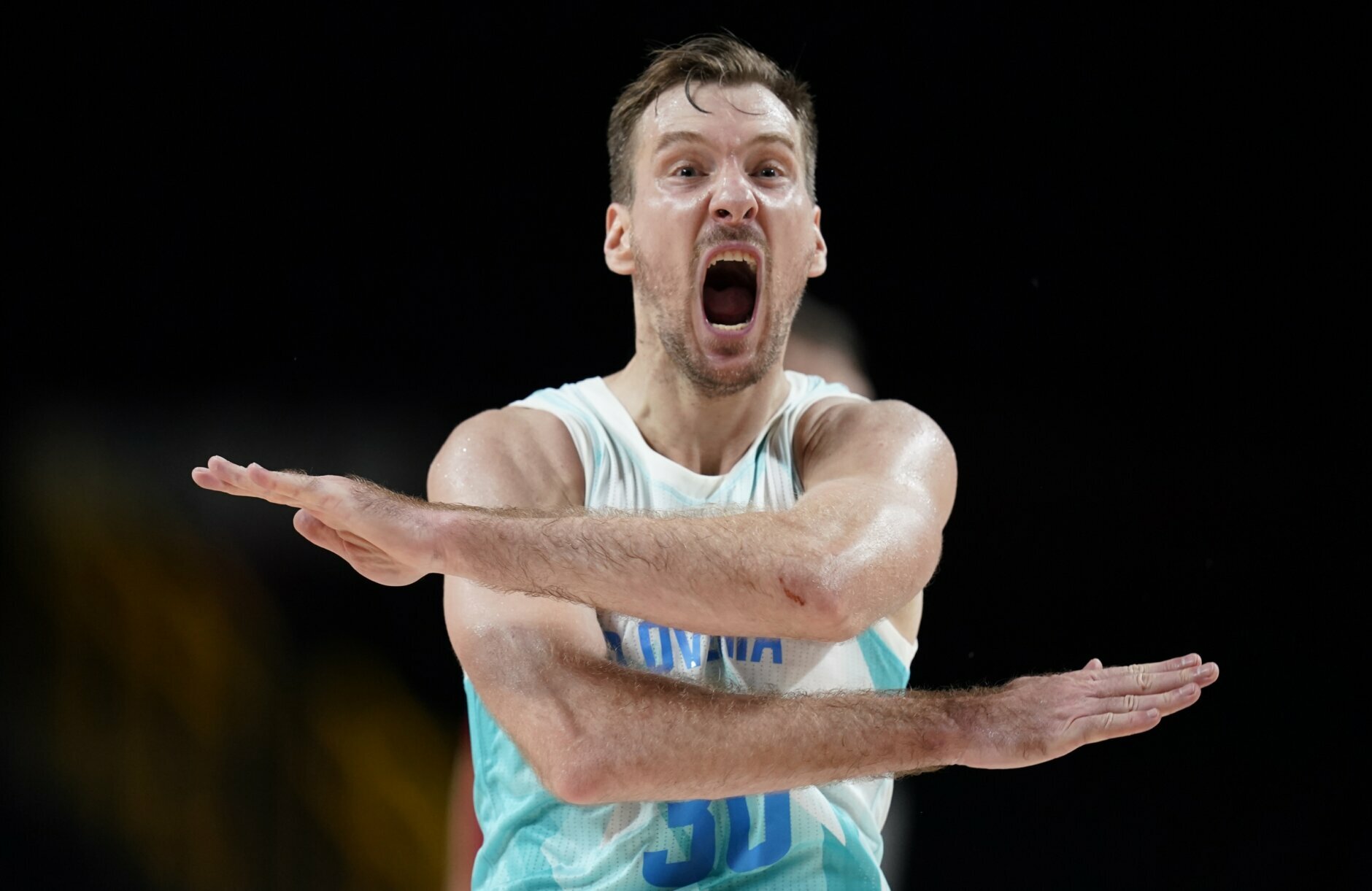 Slovenia's Zoran Dragic (30) celebrates after making a three point basket during men's basketball quarterfinal game against Germany at the 2020 Summer Olympics, Tuesday, Aug. 3, 2021, in Saitama, Japan. (AP Photo/Charlie Neibergall)