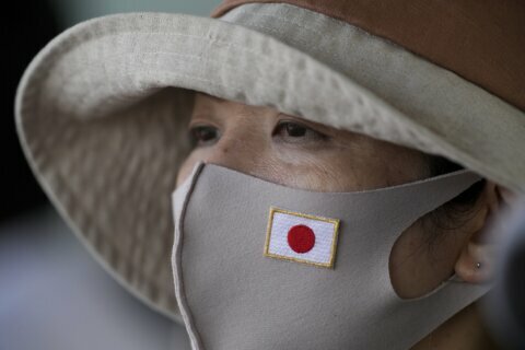 AP PHOTOS: No avoiding pandemic reminders at Tokyo Games