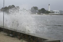 Waves crash against the sea wall near New London Harbor Lighthouse as Tropical Storm Henri approaches Sunday, Aug. 22, 2021, in New London, Conn. (AP Photo/Stew Milne)