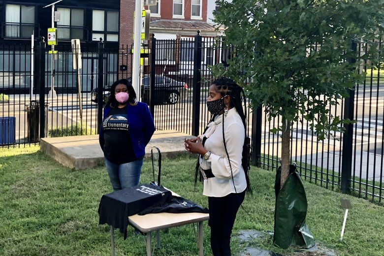 LaCondria Beckwith (left), principal of Ketcham Elementary School, and Jalin Debeuneure, daughter of 9/11 and former Ketcham teacher James Debeuneure, at a ceremony at the school on Sept. 10, 2021. (WTOP/Nick Iannelli)