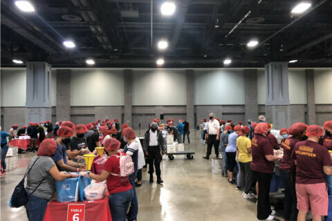 Hundreds of volunteers at DC Convention Center pack meals for hungry to mark 9/11