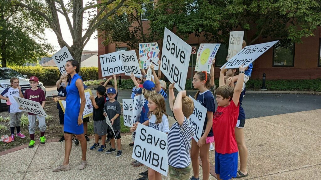 GMBL players, parents and coaches showed up for a public hearing at City Hall Sept. 13, 2021, holding a demonstration outside with signs saying “Save GMBL” and “This is our home.”