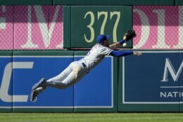New York Mets left fielder Jeff McNeil (6) leaps but cannot get to a ball that went for a ground rule double for Washington Nationals' Carter Kieboom during the seventh inning of the first baseball game of a doubleheader, Saturday, Sept. 4, 2021, in Washington. The Mets won 11-9 in extra innings. (AP Photo/Nick Wass)