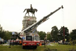 EDS NOTE: OBSCENITY - Crews prepare one of the country's largest remaining monuments to the Confederacy, a towering statue of Confederate General Robert E. Lee on Monument Avenue, Wednesday, Sept. 8, 2021, in Richmond, Va. (AP Photo/Steve Helber, Pool)