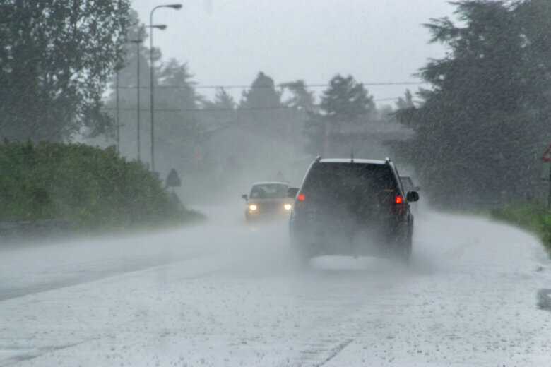 Vehicle driving through wet roadway