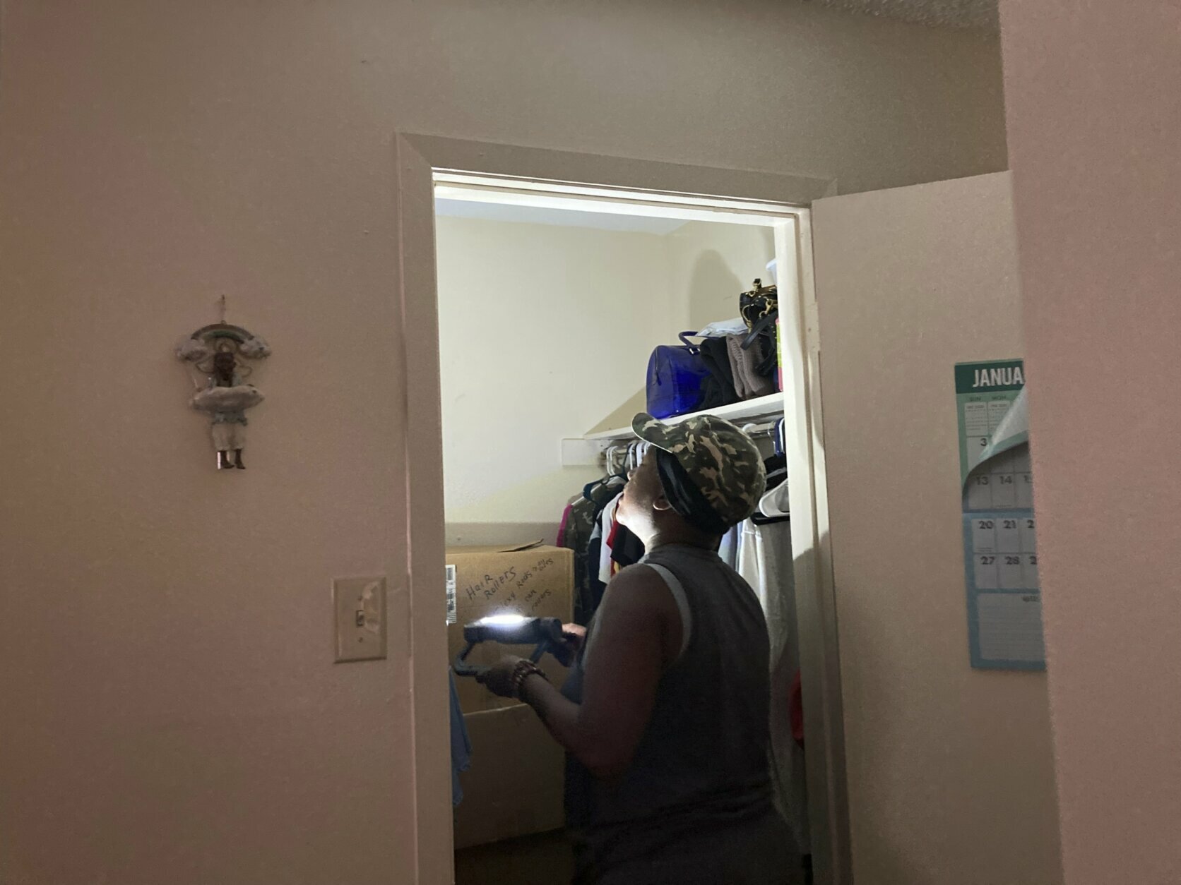 Allison Smith uses a flashlight to look at the ceiling in her Houma, La., apartment, Sunday, Sept. 5, 2021, to see whether there is any damage. Smith was in the apartment when Hurricane Ida came through and caused the ceiling in one of her bedrooms to crash on top of her. The storm caused such extensive damage to the buildings in the complex that residents have to move out. (AP Photo/Rebecca Santana)