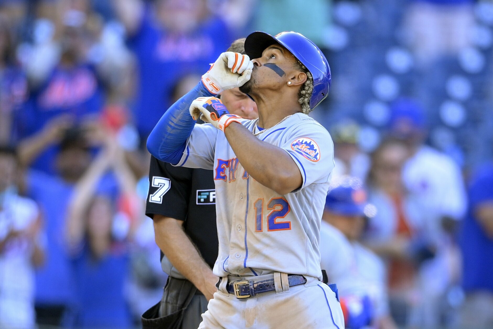 New York Mets' Francisco Lindor (12) celebrates his two-run home run during the ninth inning of the first baseball game of a doubleheader against the Washington Nationals, Saturday, Sept. 4, 2021, in Washington. The Mets won 11-9 in extra innings. (AP Photo/Nick Wass)