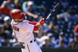 Washington Nationals' Carter Kieboom hits a broken bat single during the fourth inning of the first baseball game of a doubleheader against the New York Mets, Saturday, Sept. 4, 2021, in Washington. The Mets won 11-9 in extra innings. (AP Photo/Nick Wass)