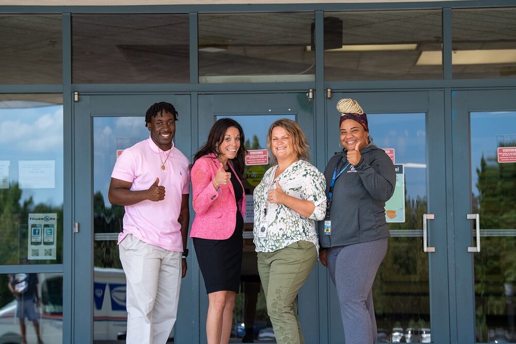 Lamar Hardy, Meredith Norris, Yvonne Wood, and Brooke Majors outside Stone Middle School.  (Courtesy Karen Bolt/FCPS)