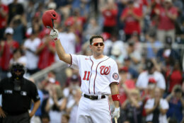 Washington Nationals' Ryan Zimmerman doffs his batting helmet to the crowd before batting during the second inning of a baseball game against the Boston Red Sox, Sunday, Oct. 3, 2021, in Washington. (AP Photo/Nick Wass)