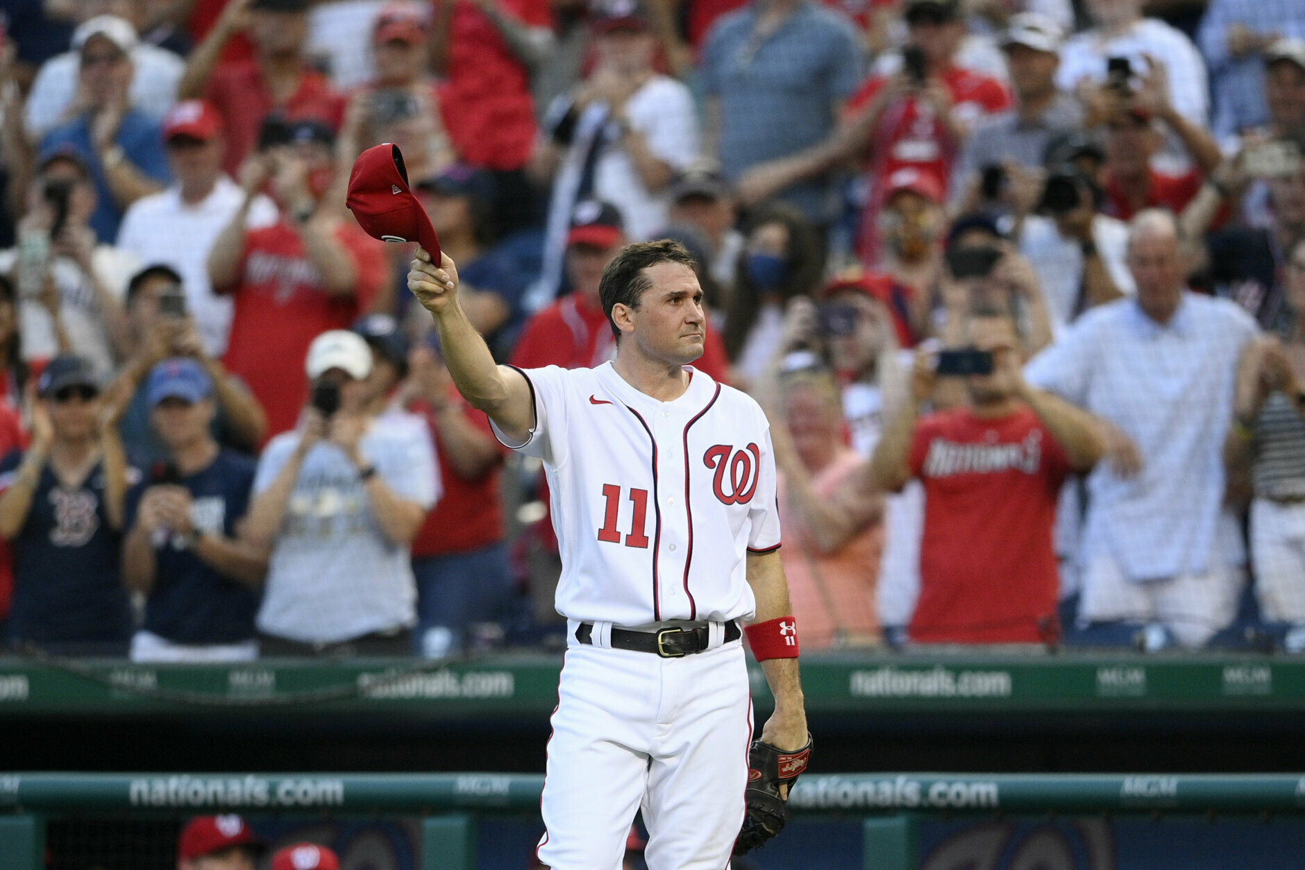 Washington Nationals' Ryan Zimmerman doffs his cap to the crowd after he came out of the game before the eighth inning of a baseball game against the Boston Red Sox, Sunday, Oct. 3, 2021, in Washington. The Red Sox won 7-5. (AP Photo/Nick Wass)