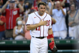 Washington Nationals' Ryan Zimmerman gestures to the crowd after he came out of a baseball game before the eighth inning against the Boston Red Sox, Sunday, Oct. 3, 2021, in Washington. (AP Photo/Nick Wass)