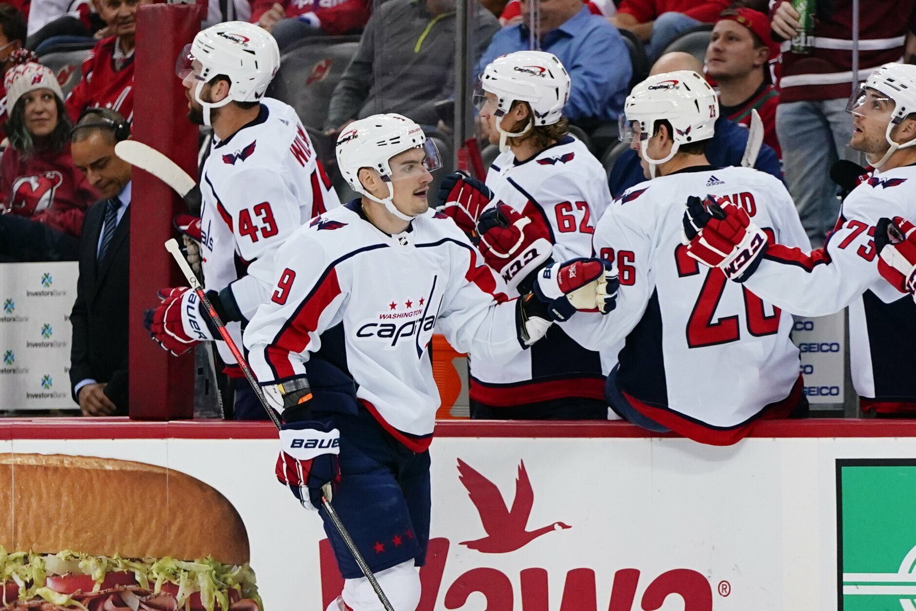 Washington Capitals' Dmitry Orlov (9) celebrates with teammates after scoring a goal during the first period of the team's NHL hockey game against the New Jersey Devils on Thursday, Oct. 21, 2021, in Newark, N.J. (AP Photo/Frank Franklin II)