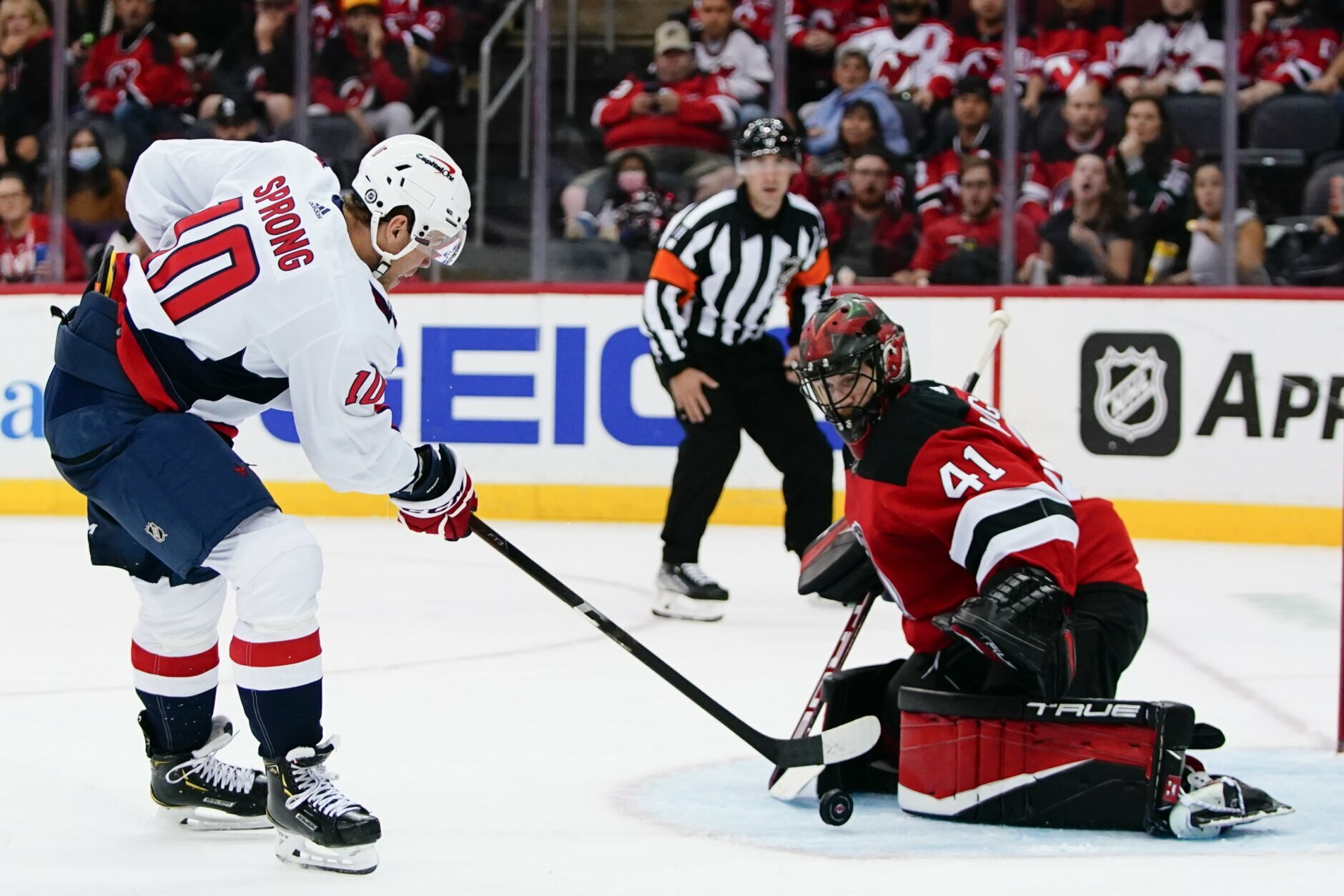 Washington Capitals' Daniel Sprong (10) shoots the puck past New Jersey Devils goaltender Scott Wedgewood (41) for a goal during the second period of an NHL hockey game Thursday, Oct. 21, 2021, in Newark, N.J. (AP Photo/Frank Franklin II)