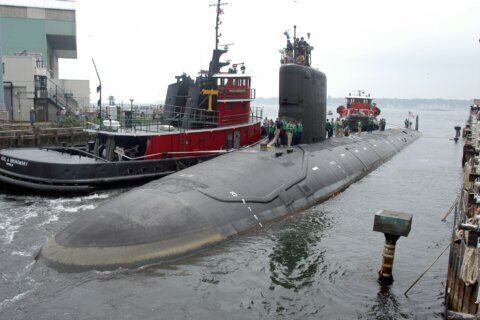 Couple in submarine spy case to remain held; hearing set