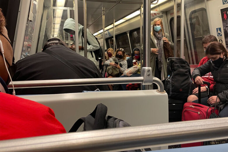 Commuters ride a Blue Line Metro train
