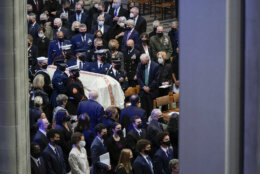 President Joe Biden watches as the casket of former Secretary of State Colin Powell is carried during a funeral service at the Washington National Cathedral, in Washington, Friday, Nov. 5, 2021. (AP Photo/Evan Vucci)
