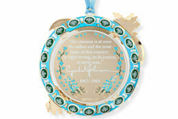 The back of the ornament features an engraving of a quote from President Johnson’s address to a joint session of Congress on March 15, 1965 in response to the violence in Selma, Alabama and the attack by law enforcement and counter protestors civil rights activists.