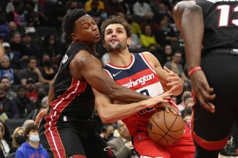 Wizards beat Heat 103-100 to split home-and-home series